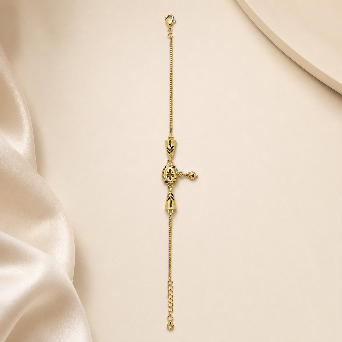 Oval floral charm bracelet laid straight on ivory satin