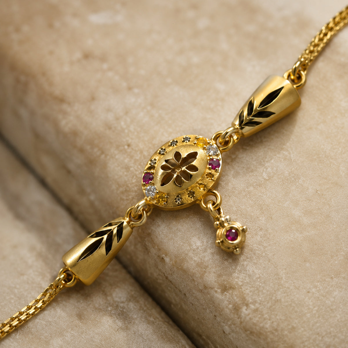 Close-up of the oval floral centre, multicolour stones and hanging charm