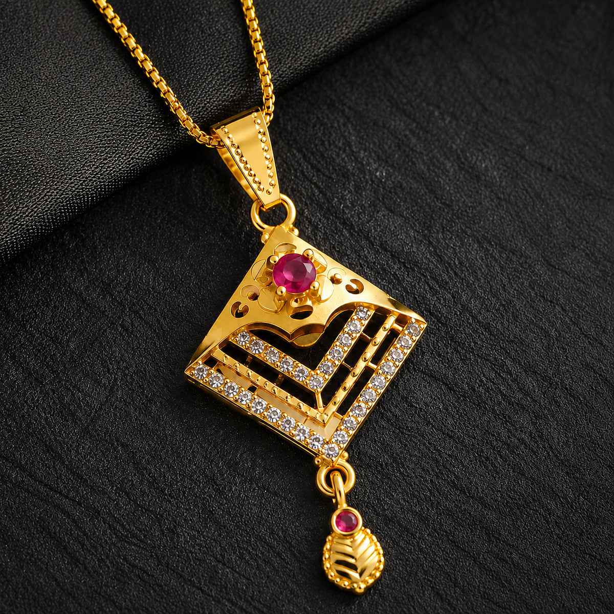 Close-up of the red stone, clear chevron detailing and hanging drop