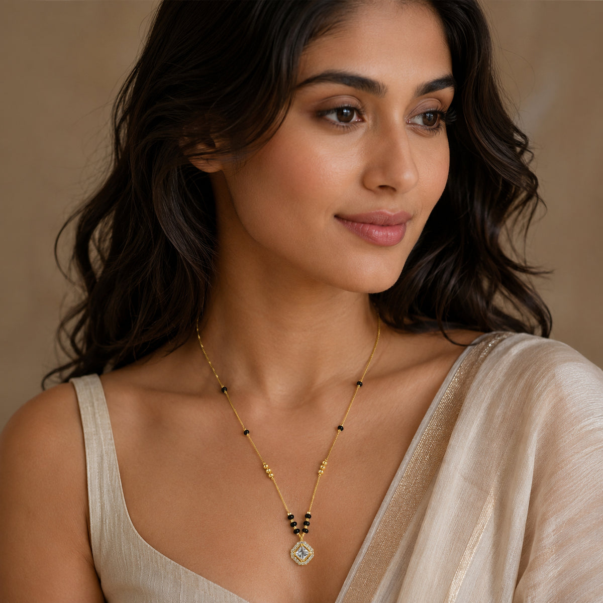 Woman wearing the gold-tone black bead mangalsutra with square pendant