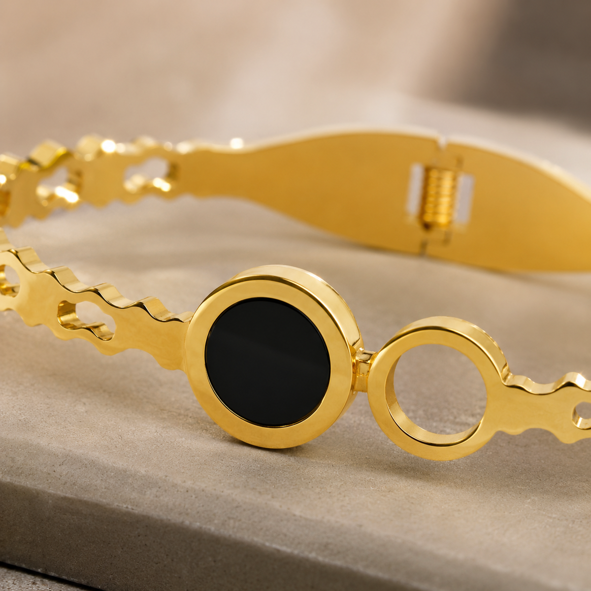 Close-up of the black disc, open circle and cut-out gold-tone band