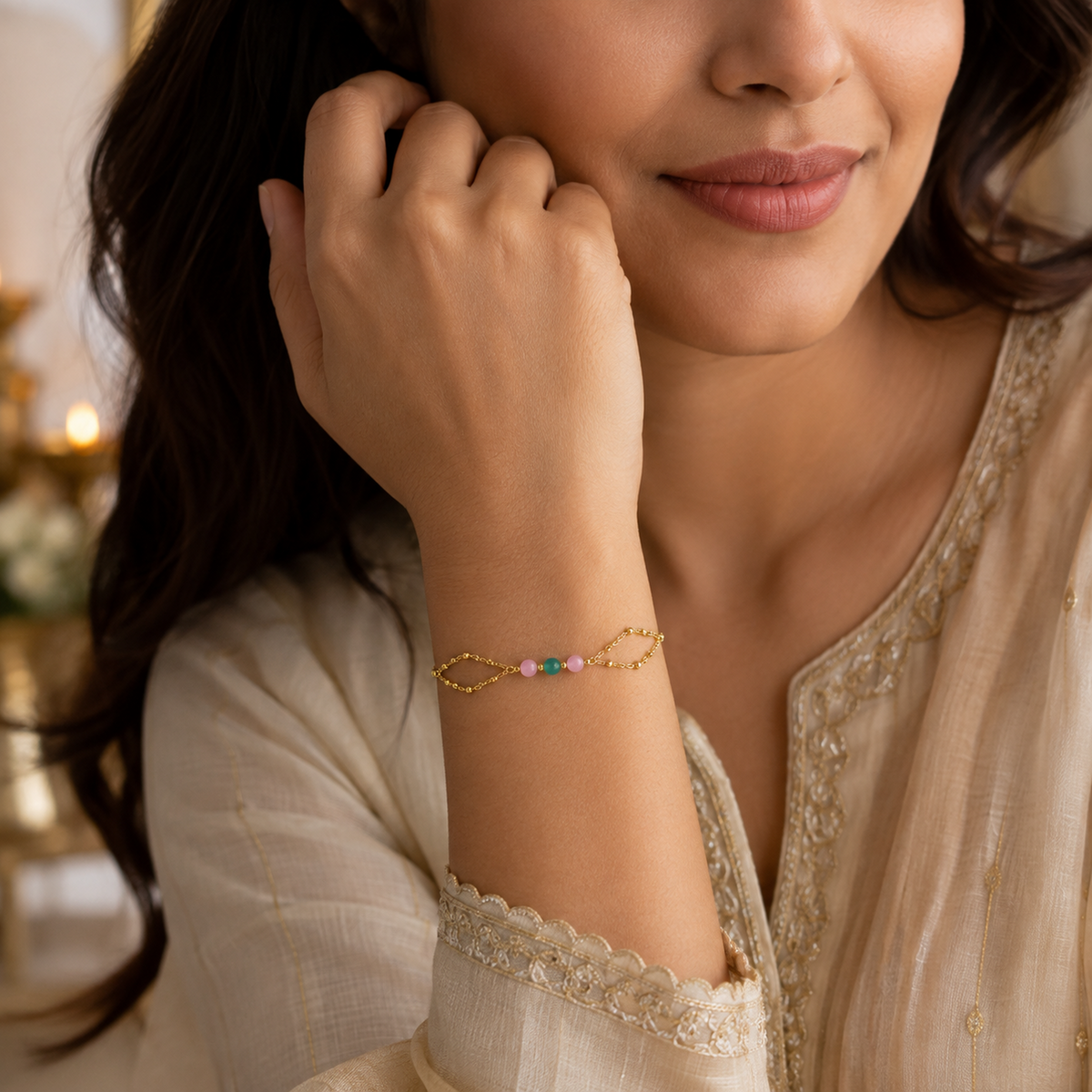 Double-chain bracelet worn with a cream embroidered outfit
