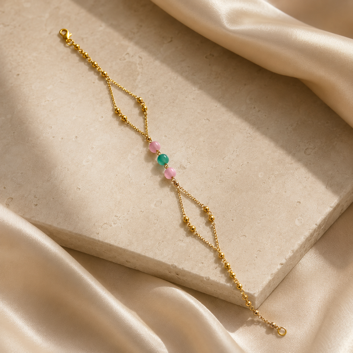 Beaded bracelet arranged diagonally beside draped ivory satin