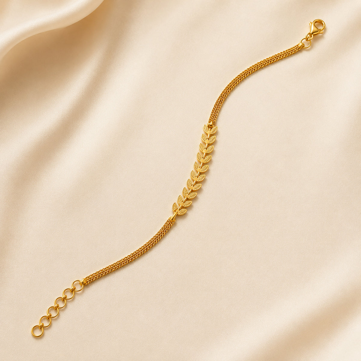 Leaf motif bracelet with lobster clasp and extension chain on ivory satin