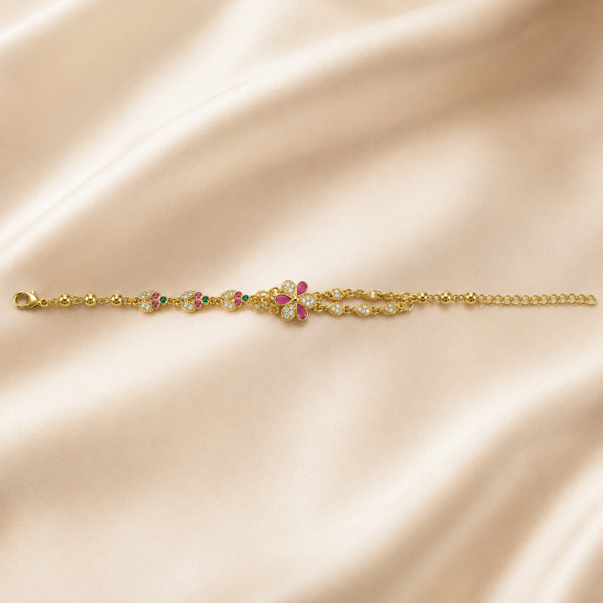 Multicolour floral bracelet laid straight across ivory satin