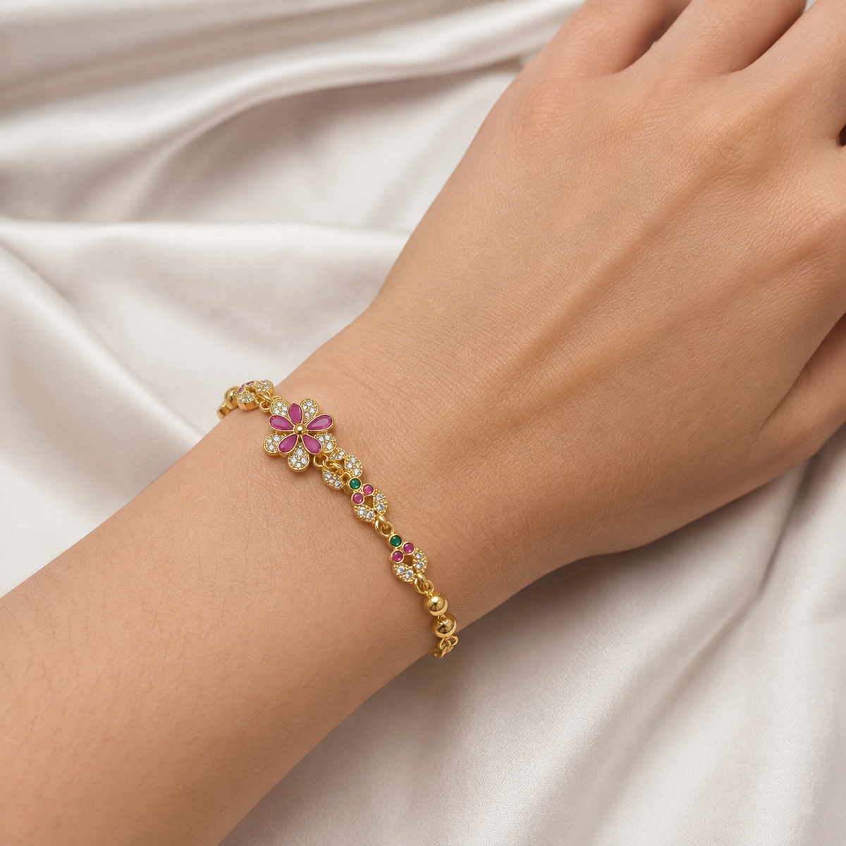 Pink and green floral bracelet shown around a wrist