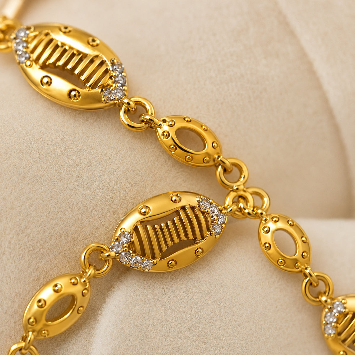 Close-up of ribbed oval links, dotted detailing and clear stone accents