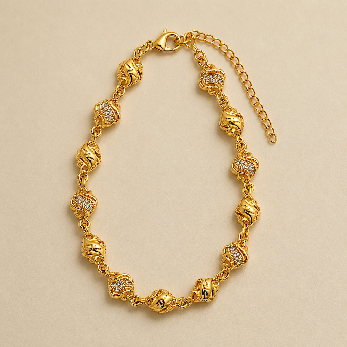 Wave and bead link bracelet arranged on a pale surface