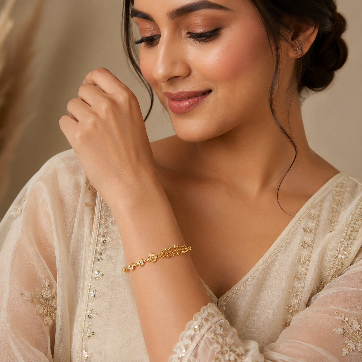 Floral multi-chain bracelet worn with a cream saree