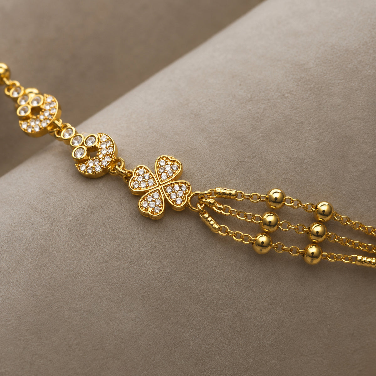 Close-up of the four-petal flower, clear stones and beaded chains
