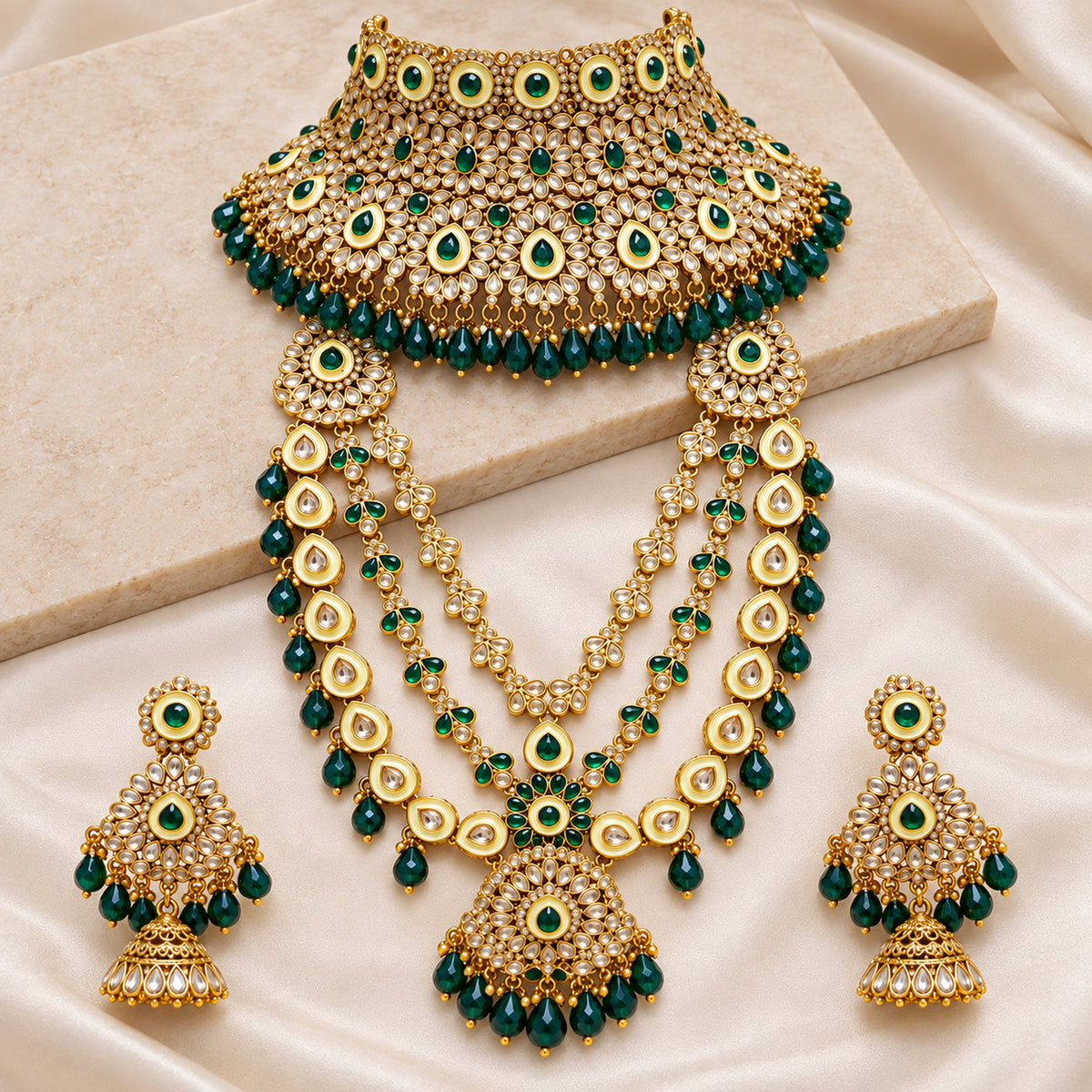 Emerald green bridal set with layered haar and jhumka earrings on cream fabric