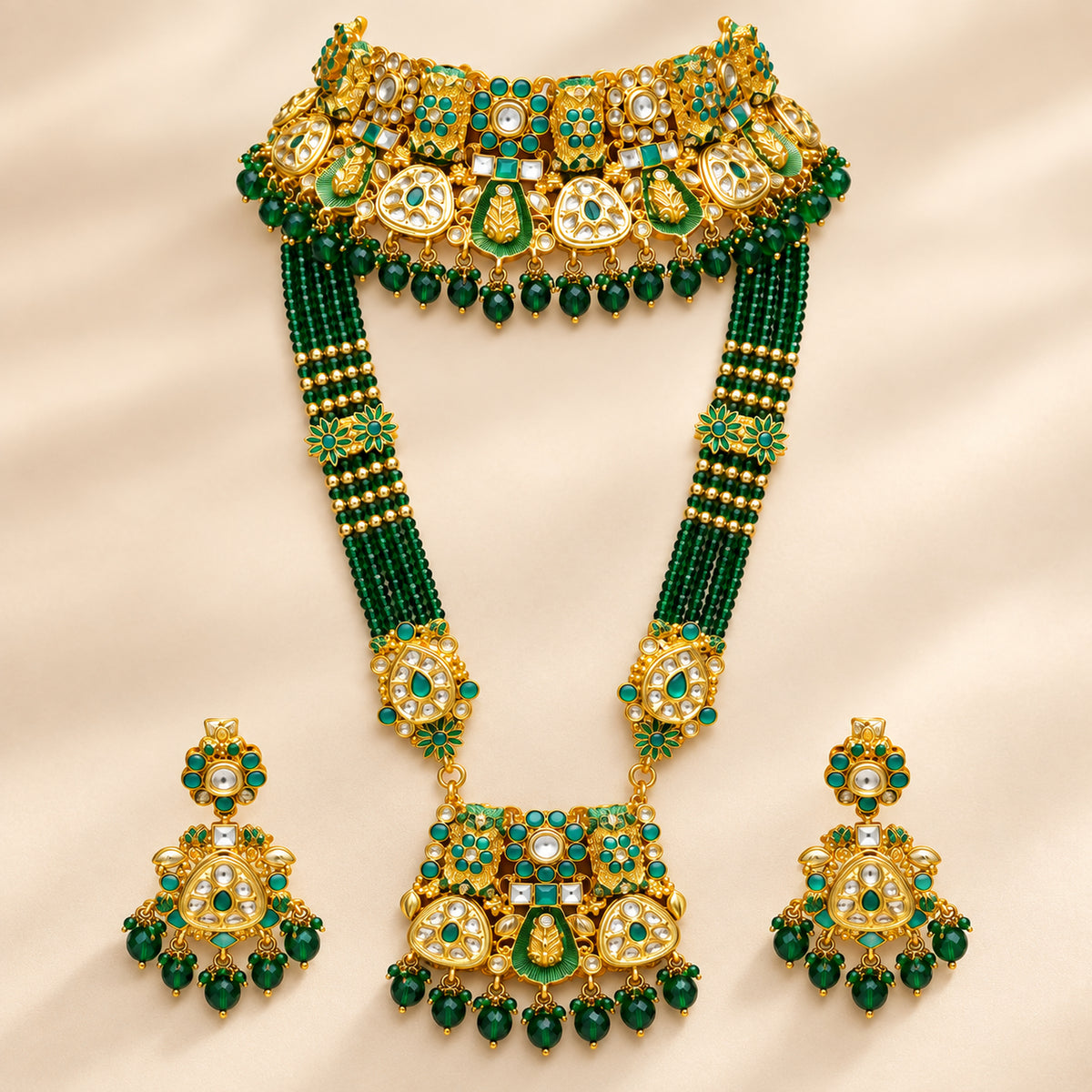 Emerald green bridal choker and multi-strand haar displayed with matching earrings