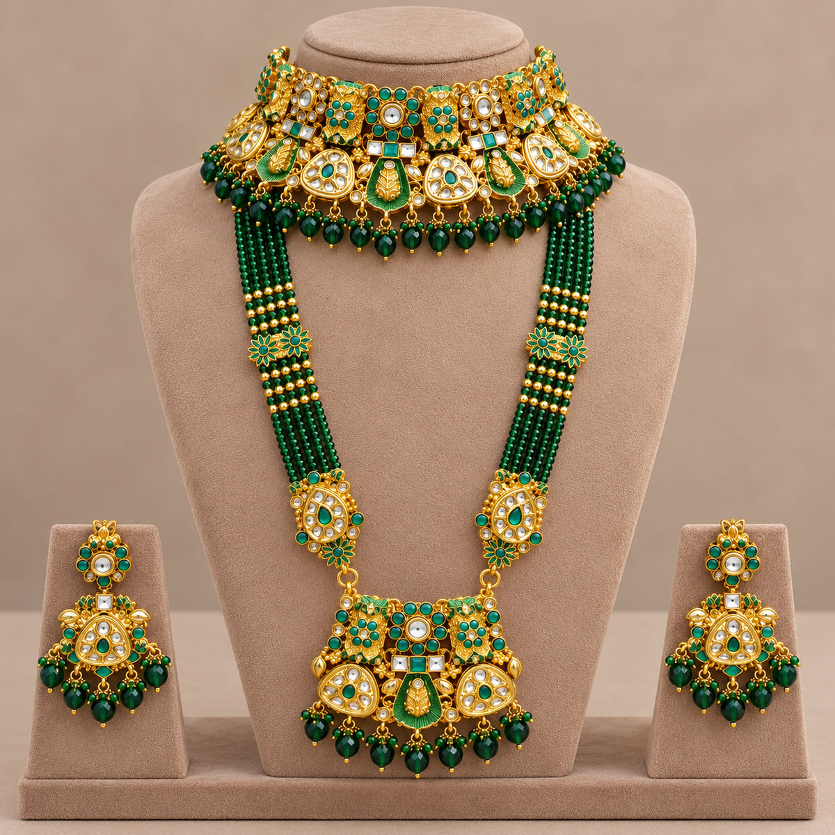 Emerald green bridal necklace set and earrings arranged on a display tray