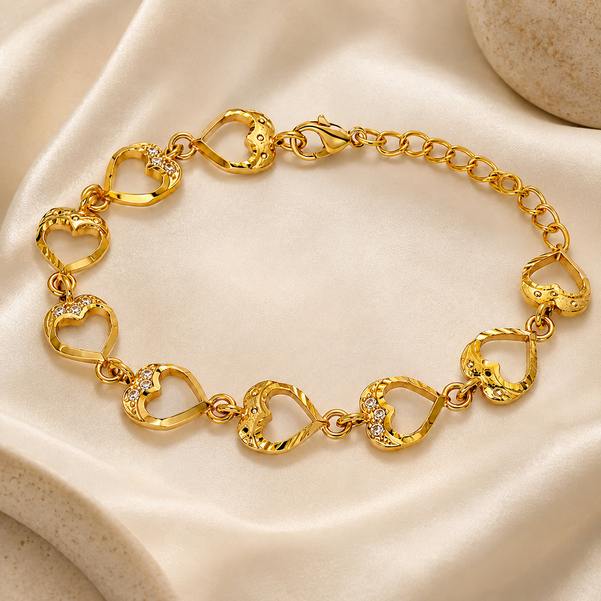 Heart link bracelet arranged on ivory satin with clasp and extender
