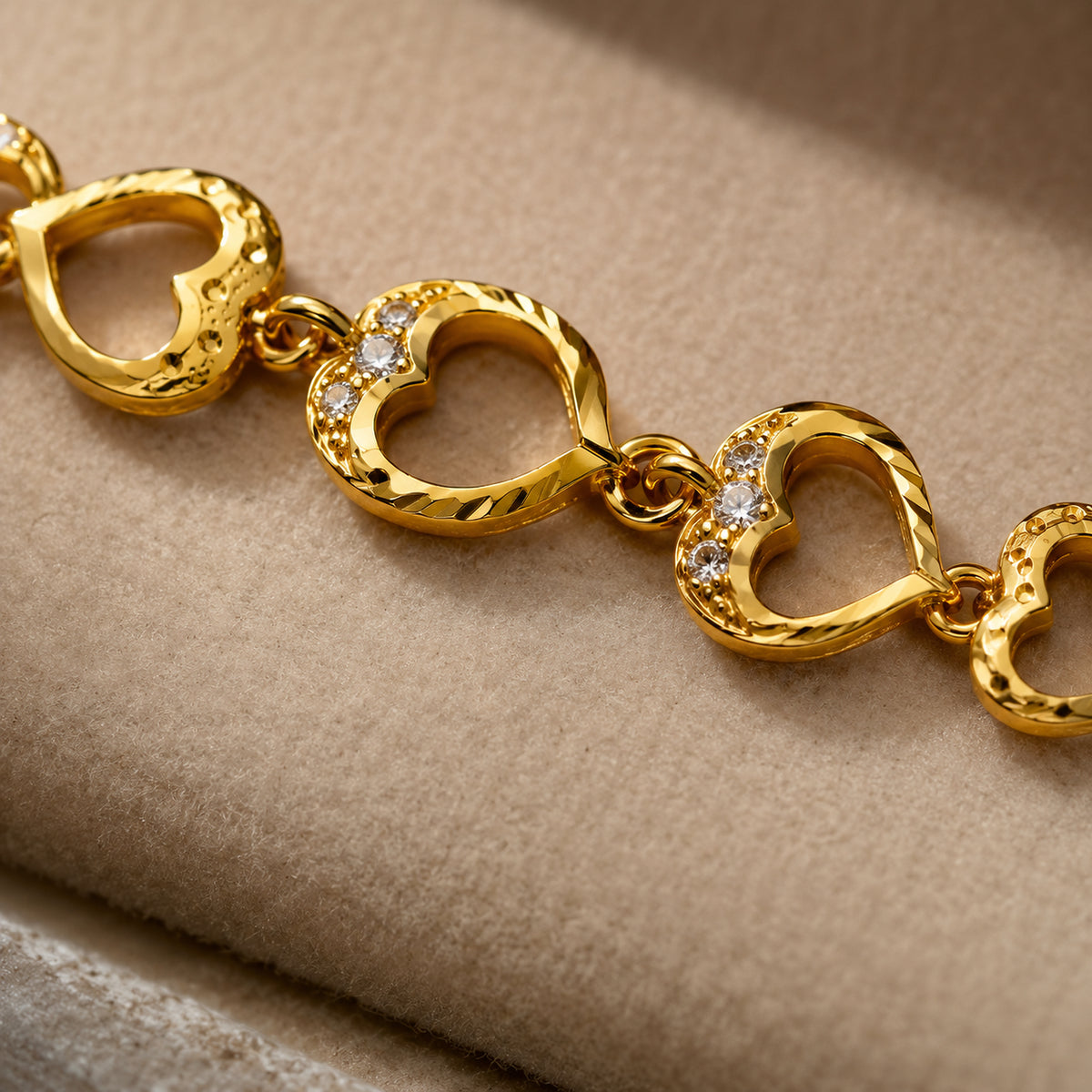 Close-up of textured heart links and clear decorative stone accents