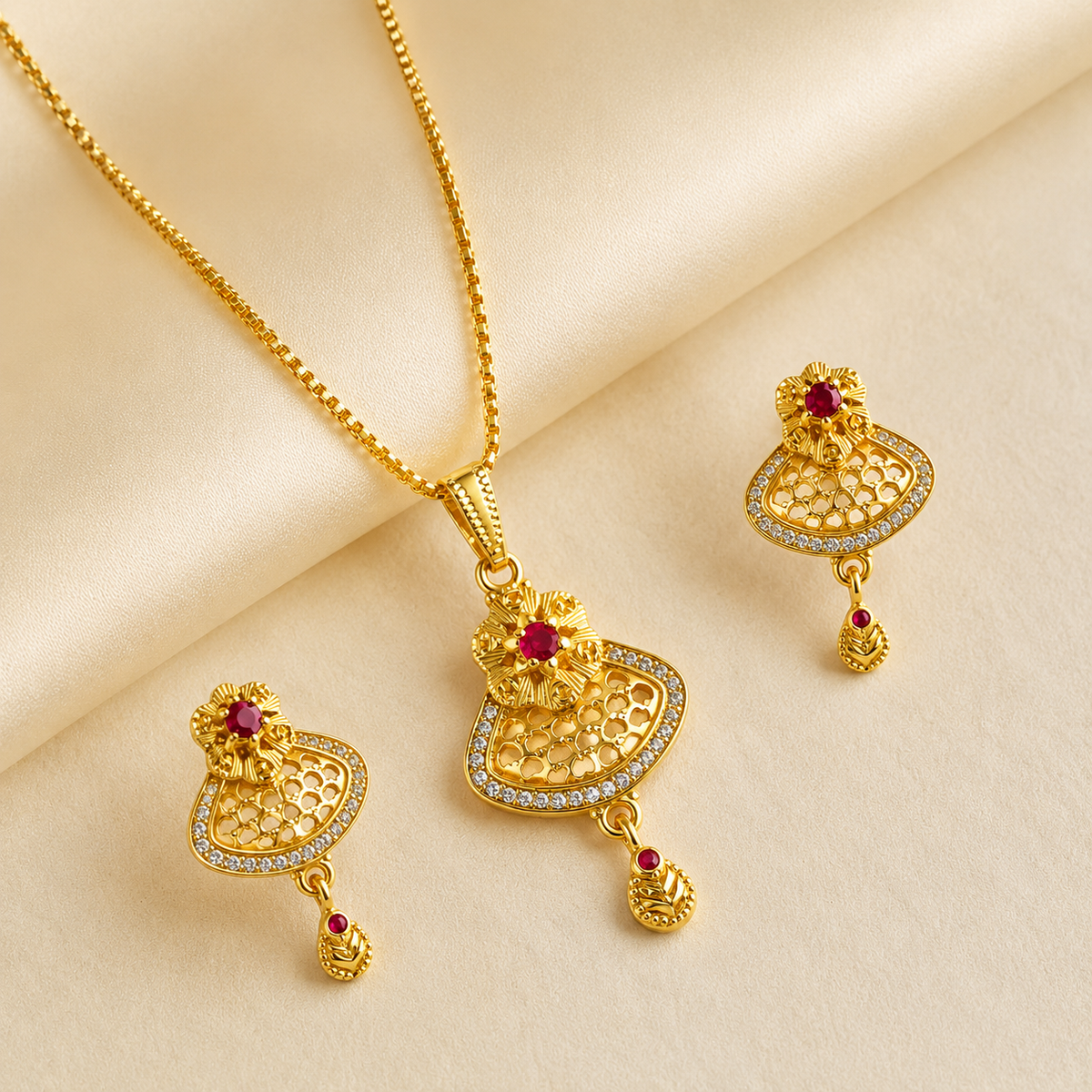Fan-shaped openwork pendant and magenta-accent earrings arranged on ivory satin