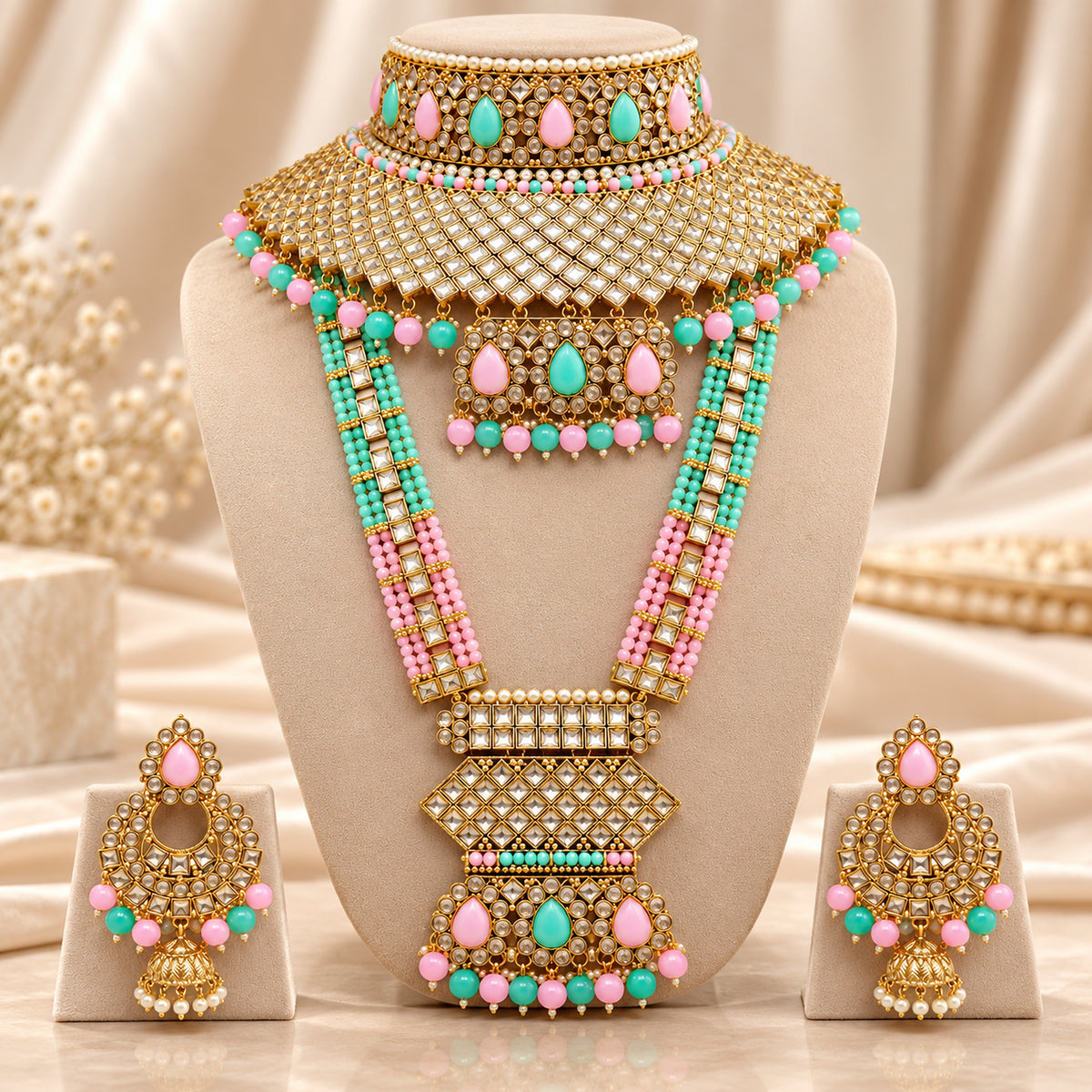 Pink and mint green lattice bridal set displayed on a beige bust with matching earrings