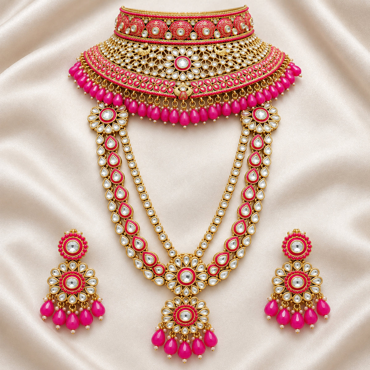 Rani pink choker, long haar and drop earrings arranged on cream fabric