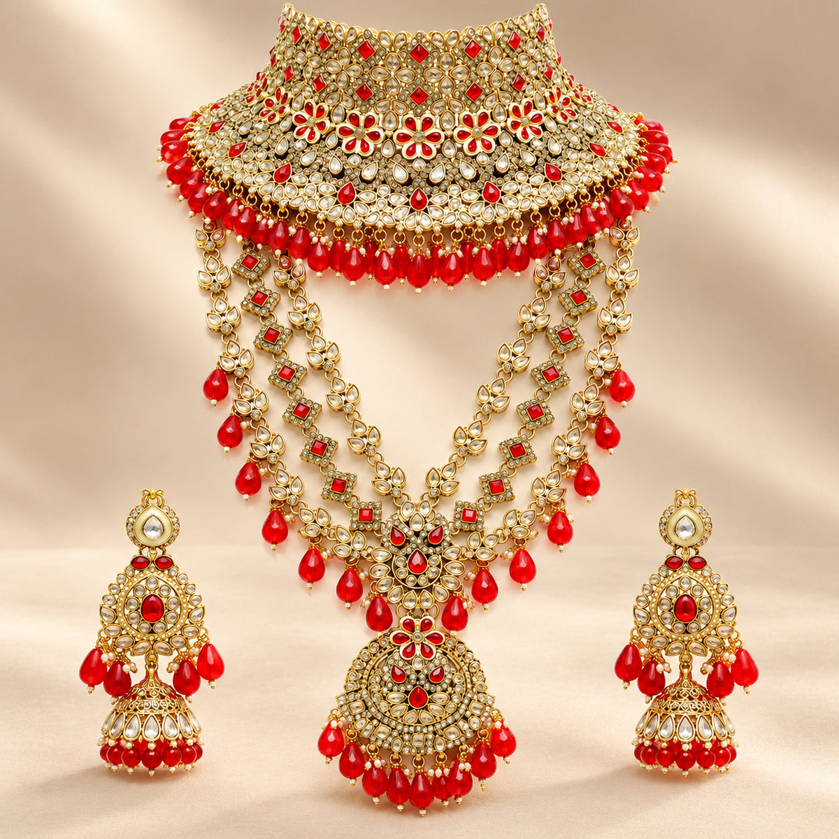 Red and clear-stone bridal choker and layered haar on a beige bust with matching earrings