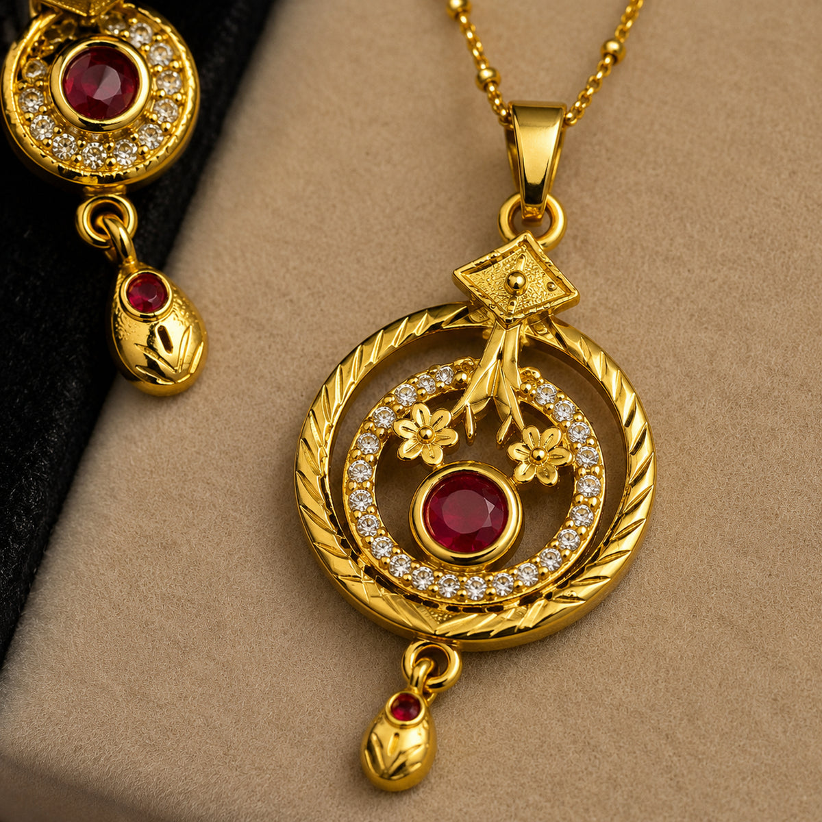 Close-up of the floral pendant with red centre, clear halo and hanging drop